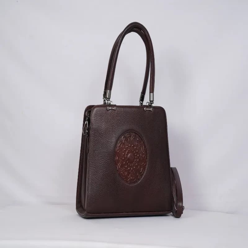 Handcrafted Leather Satchel Mandala-embossed circular patch.